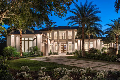 Huge two-story stucco house exterior idea in Other