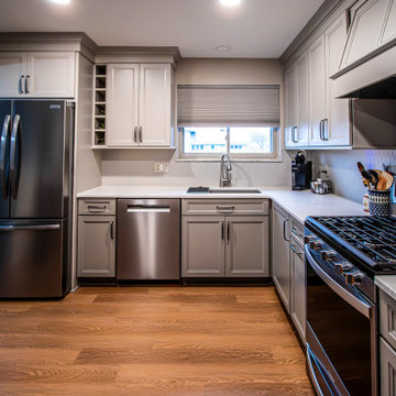 Two-Tone Neutral Kitchen with Quartz Countertop and Soho Picket Backsplash