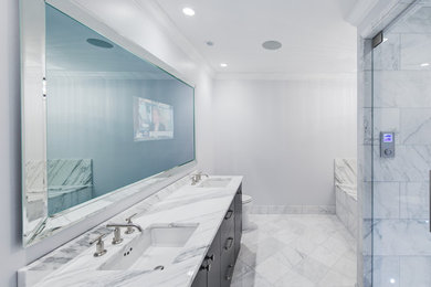 This is an example of a large transitional bathroom in Chicago with an undermount sink, flat-panel cabinets, dark wood cabinets, marble benchtops, an undermount tub, a one-piece toilet, white tile, stone tile, white walls, marble floors and with a sauna.