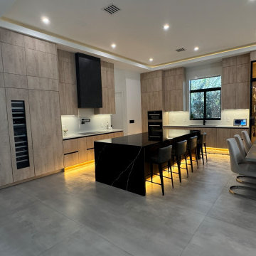 Luxury Modern Kitchen with Hidden Panel-Ready Refrigerator and Statement Hood