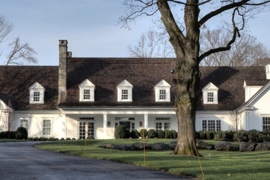 Large traditional white two-story wood exterior home idea in New York