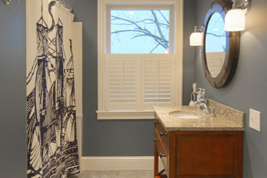 Inspiration for a mid-sized timeless kids' white tile and porcelain tile porcelain tile bathroom remodel with furniture-like cabinets, dark wood cabinets, marble countertops and blue walls