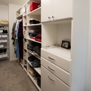 White Vanity with Freestanding Tub and Tiled Shower with Closet Storage