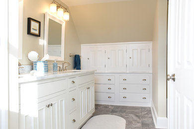 Mid-sized traditional master bathroom in Providence with white cabinets, a shower/bathtub combo, a one-piece toilet, white tile, ceramic tile, beige walls, ceramic floors, marble benchtops, beaded inset cabinets, an alcove tub, a wall-mount sink, grey floor and a sliding shower screen.