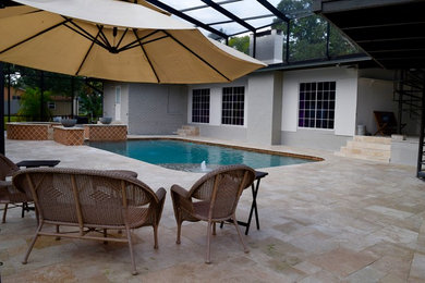 Inspiration for a large contemporary backyard stone and rectangular lap pool fountain remodel in Tampa