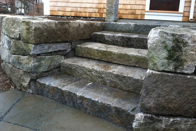 This is an example of a front yard stone retaining wall landscape in Manchester.