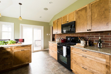 Inspiration for a small galley enclosed kitchen remodel in St Louis with an undermount sink, shaker cabinets, light wood cabinets, granite countertops, black appliances and no island
