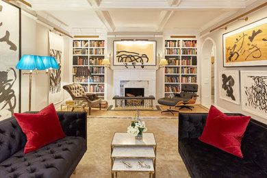 Inspiration for a mid-sized transitional enclosed family room in New York with a standard fireplace, a stone fireplace surround, a library, beige walls, carpet and beige floor.