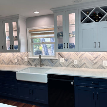 White upper cabinets with blue base cabinets with cabinet lighting