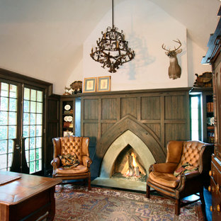 Ejemplo de despacho clásico con paredes beige, chimenea tradicional y marco de chimenea de hormigón