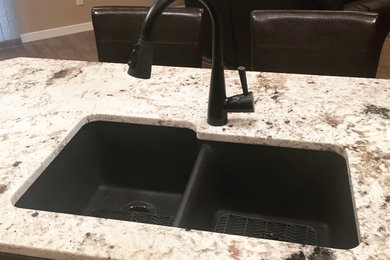 This is an example of a kitchen in Other with an undermount sink, granite benchtops and with island.