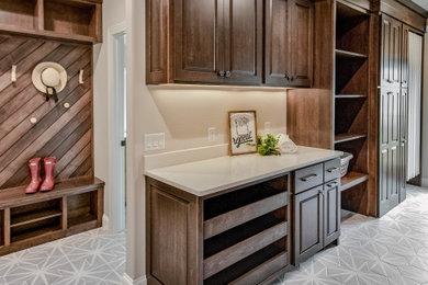 Utility room - transitional porcelain tile and gray floor utility room idea in Other with raised-panel cabinets, dark wood cabinets, quartz countertops and white countertops