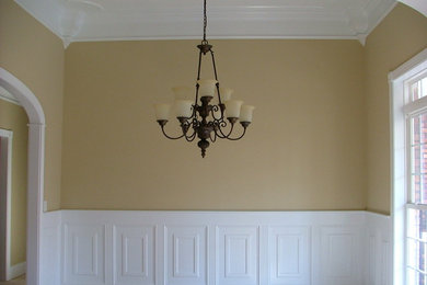 Elegant medium tone wood floor dining room photo in Other with beige walls