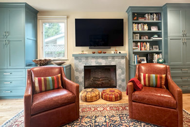 Mid-sized transitional enclosed medium tone wood floor and brown floor family room photo in San Francisco with beige walls, a standard fireplace, a tile fireplace and a wall-mounted tv