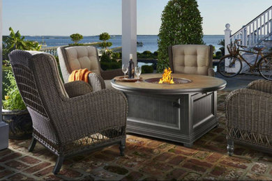 Patio - mid-sized coastal backyard brick patio idea in Other with a fire pit and a roof extension