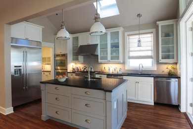 Mid-sized transitional dark wood floor kitchen photo in DC Metro with an undermount sink, shaker cabinets, white cabinets, gray backsplash, subway tile backsplash, stainless steel appliances and an island