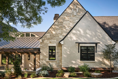 Example of a large french country white split-level mixed siding exterior home design in Denver