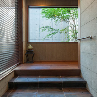 This is an example of an asian vestibule in Tokyo with beige walls.