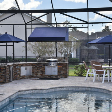 Outdoor kitchen with Evo flat top grill and separate server/sink area.