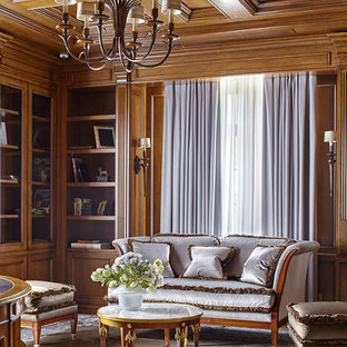 Пример оригинального дизайна интерьера: кабинет в классическом стиле с библиотекой, ковровым покрытием и серым полом