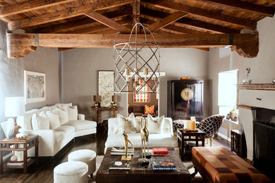 Example of a tuscan formal and open concept dark wood floor living room design in Los Angeles with gray walls, a standard fireplace and no tv