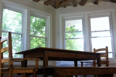 Example of a large mountain style dark wood floor great room design in DC Metro with white walls