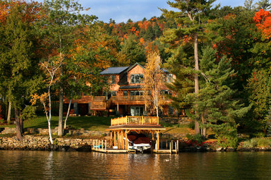 Huge mountain style beige three-story wood gable roof photo in Boston