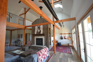 Mid-sized mountain style open concept dark wood floor and brown floor family room photo in Other with a standard fireplace, a wood fireplace surround and white walls