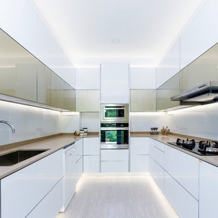 Design ideas for a medium sized modern u-shaped kitchen/diner in Singapore with a submerged sink, flat-panel cabinets, stainless steel appliances and no island.