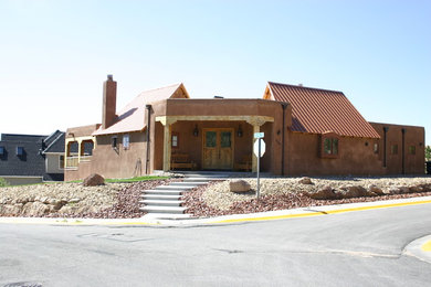 Example of a southwest stucco exterior home design in Albuquerque