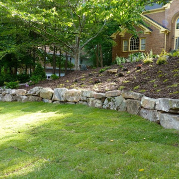 Boulder Retaining Wall by Outdoor Makeover