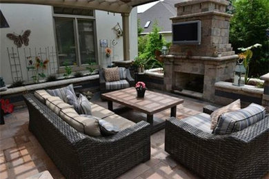 Inspiration for a large transitional backyard patio in Columbus with a fire feature, concrete pavers and a pergola.