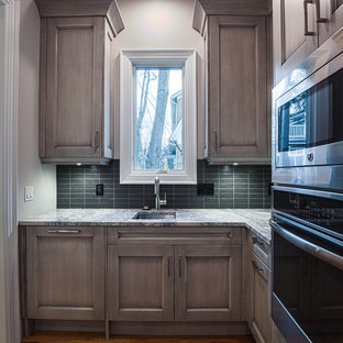 Large transitional kitchen pantry inspiration - Inspiration for a large transitional l-shaped medium tone wood floor kitchen pantry remodel in Detroit with an undermount sink, recessed-panel cabinets, gray cabinets, stainless steel appliances, an island, quartzite countertops, gray backsplash and glass tile backsplash