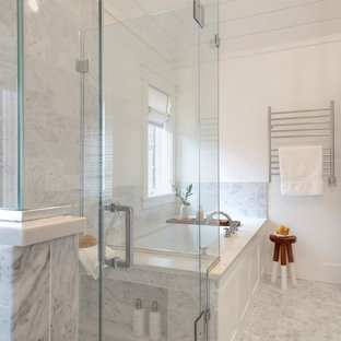Photo of a large transitional master bathroom in Chicago with shaker cabinets, white cabinets, an alcove tub, a curbless shower, a one-piece toilet, white walls, marble floors, an undermount sink, quartzite benchtops, grey floor, a hinged shower door, white benchtops, a shower seat, a double vanity, a built-in vanity and timber.