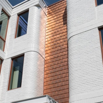 Copper shingles over the shared front entry