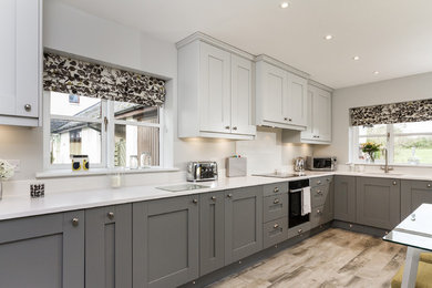 Design ideas for a medium sized eclectic kitchen in Other with a single-bowl sink, shaker cabinets, grey cabinets, composite countertops, white splashback, integrated appliances, ceramic flooring and grey floors.