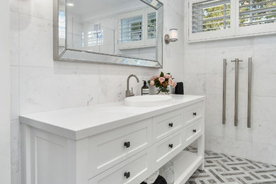 Large modern master bathroom in Sydney with shaker cabinets, white cabinets and white benchtops.