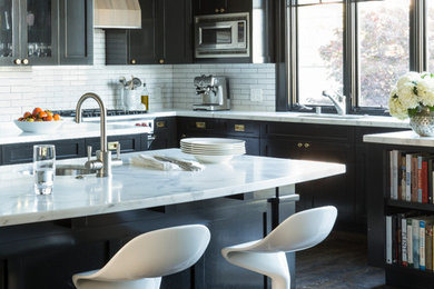 Enclosed kitchen - transitional l-shaped medium tone wood floor enclosed kitchen idea in San Francisco with shaker cabinets, marble countertops, white backsplash, subway tile backsplash, stainless steel appliances and an island