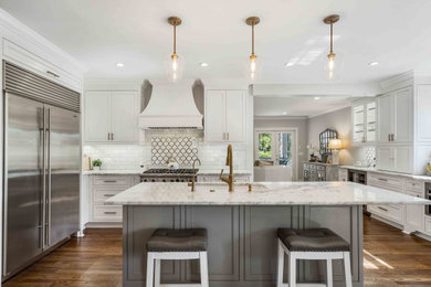 Kitchen - mid-sized transitional medium tone wood floor kitchen idea in Atlanta with shaker cabinets, white cabinets, marble countertops, white backsplash, marble backsplash, stainless steel appliances, an island and white countertops