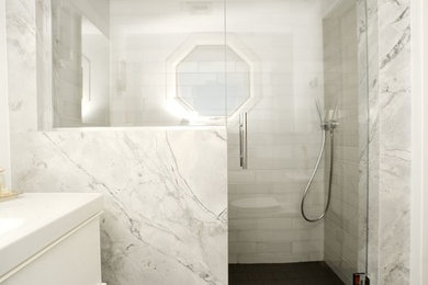 Design ideas for a mid-sized contemporary 3/4 bathroom in Boston with flat-panel cabinets, white cabinets, an alcove shower, a one-piece toilet, blue tile, ceramic tile, white walls, porcelain floors, an integrated sink and solid surface benchtops.