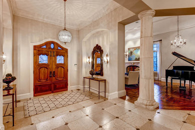 Huge elegant entryway photo in Denver with a medium wood front door