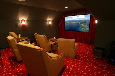 This is an example of a mid-sized modern enclosed home theatre in Dallas with brown walls, carpet and a projector screen.