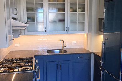 Eat-in kitchen - transitional galley medium tone wood floor and beige floor eat-in kitchen idea in New York with an undermount sink, shaker cabinets, gray cabinets, quartz countertops, white backsplash, stainless steel appliances and no island