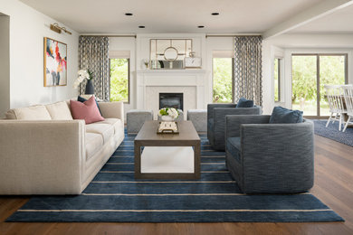 Example of a large transitional formal and enclosed light wood floor and brown floor living room design in Phoenix with white walls, a standard fireplace, a stone fireplace and no tv