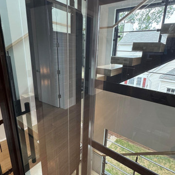 Project #136 | Modern Floating Staircase Encircling Glass Elevator