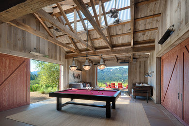 Inspiration for a huge cottage enclosed concrete floor and brown floor game room remodel in San Francisco with gray walls and a concealed tv