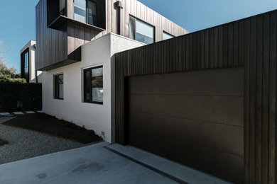 Mid-sized contemporary two-storey house exterior in Canberra - Queanbeyan with metal siding, a flat roof, a metal roof and a grey roof.