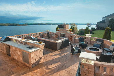 Elegant concrete paver patio kitchen photo in Other