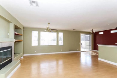 Living room - modern open concept laminate floor living room idea in Las Vegas with green walls