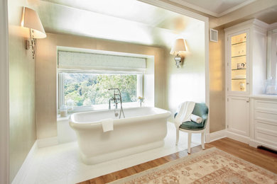 Transitional freestanding bathtub photo in Los Angeles with recessed-panel cabinets and white cabinets